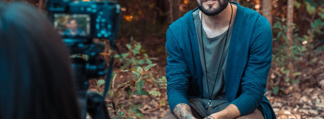photo of a man sitting in front of a camera