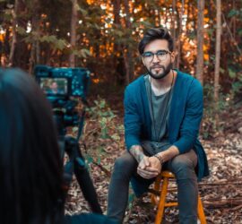 photo of a man sitting in front of a camera