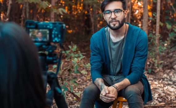 photo of a man sitting in front of a camera
