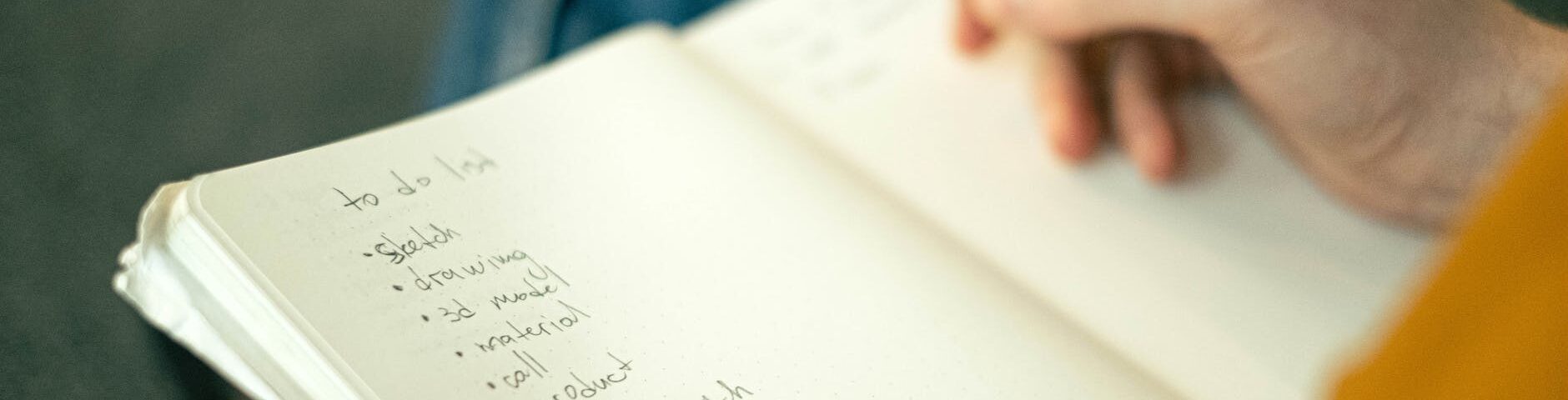 person writing a to do list