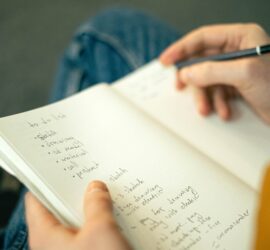 person writing a to do list