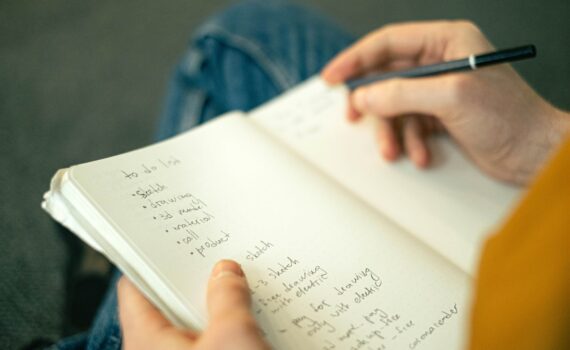 person writing a to do list
