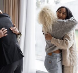 happy friends hugging each other