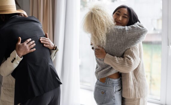 happy friends hugging each other