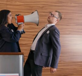 woman shouts on man using megaphone