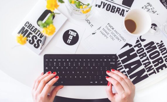 girl writing on a black keyboard