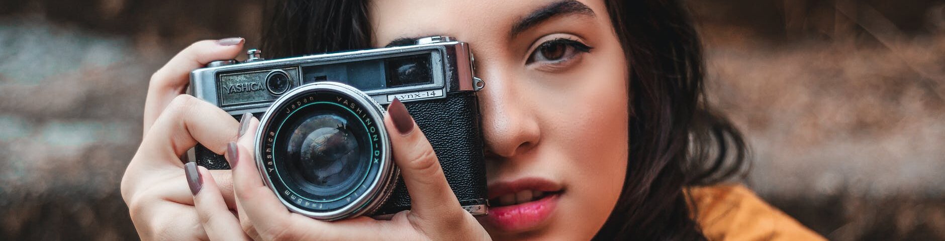 woman holding black camera
