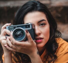woman holding black camera