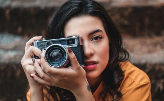 woman holding black camera