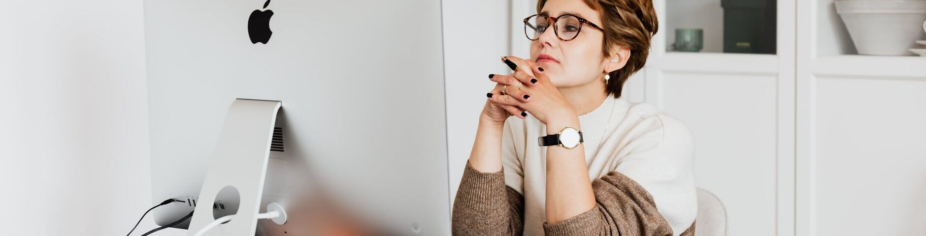 focused female employee reading information on computer in office