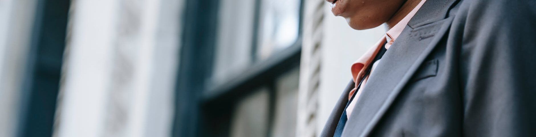 crop concentrated ethnic businesswoman with smartphone