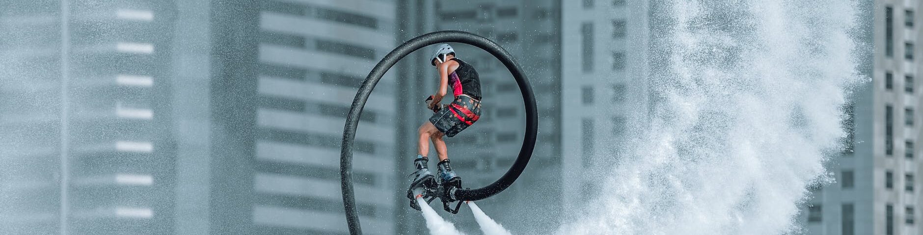 man in red jacket riding bicycle on white water wave