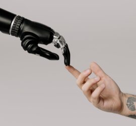 bionic hand and human hand finger pointing
