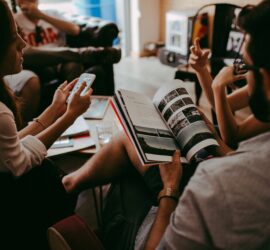 group of people reading book sitting on chair