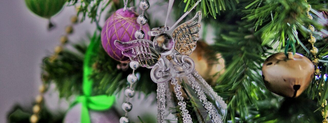 An angel decoration hanging on a Christmas tree