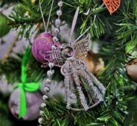 An angel decoration hanging on a Christmas tree