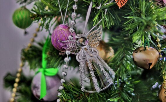 An angel decoration hanging on a Christmas tree